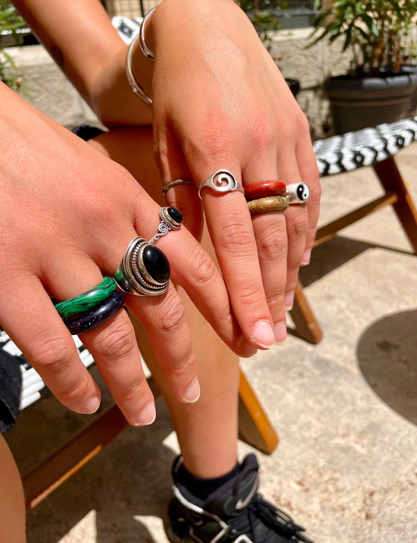 four stone rings on female model in palermo italy, outdoors in sun