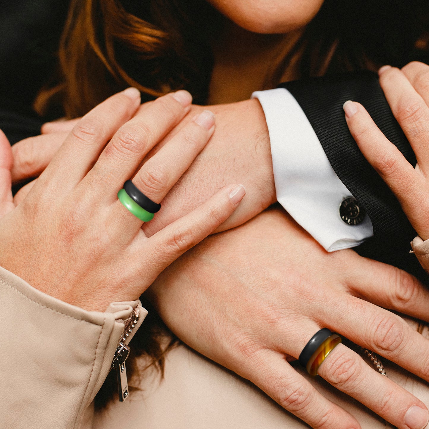 black onyx green agate and tortoise shell agate rings worn on hands of man and woman