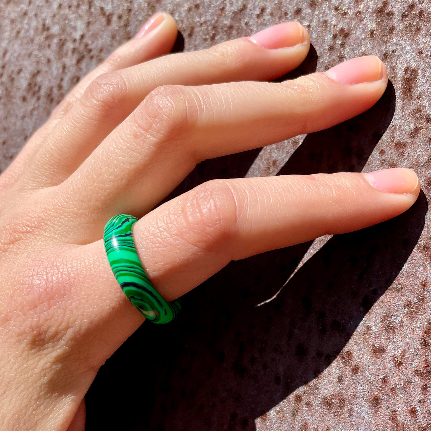 whitestone jewelry co. malachite stone band ring worn by woman