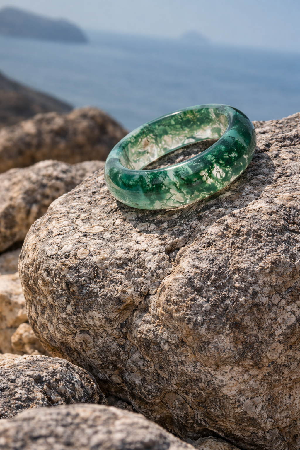 Moss agate ring resting on rock