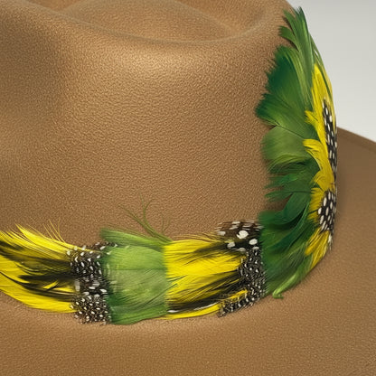 Feathered headband with green and yellow feathers on a red background