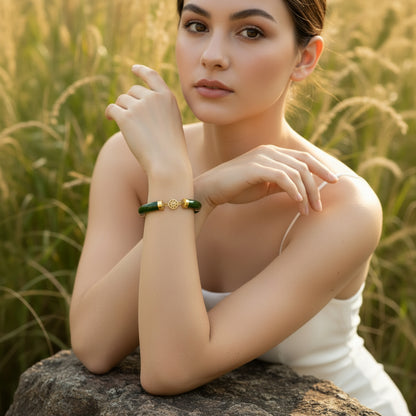 Green jade bracelet with gold accents on a woman's wrist