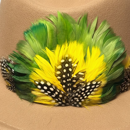 Feathered hair accessory with green, yellow, and black feathers on a red background