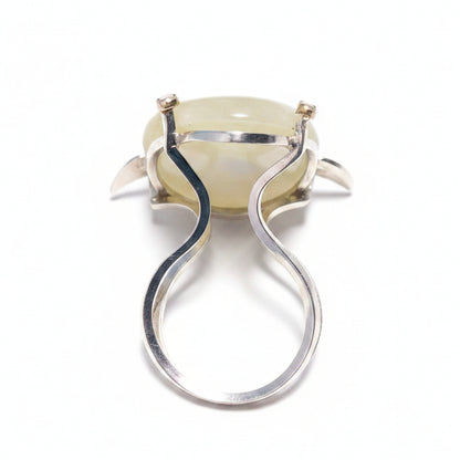 mother of pearl shark head ring and silver band on a white background