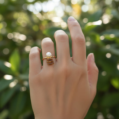 woman wearing a 18K gold plated ring with gold coal and mother of pearl attached to top